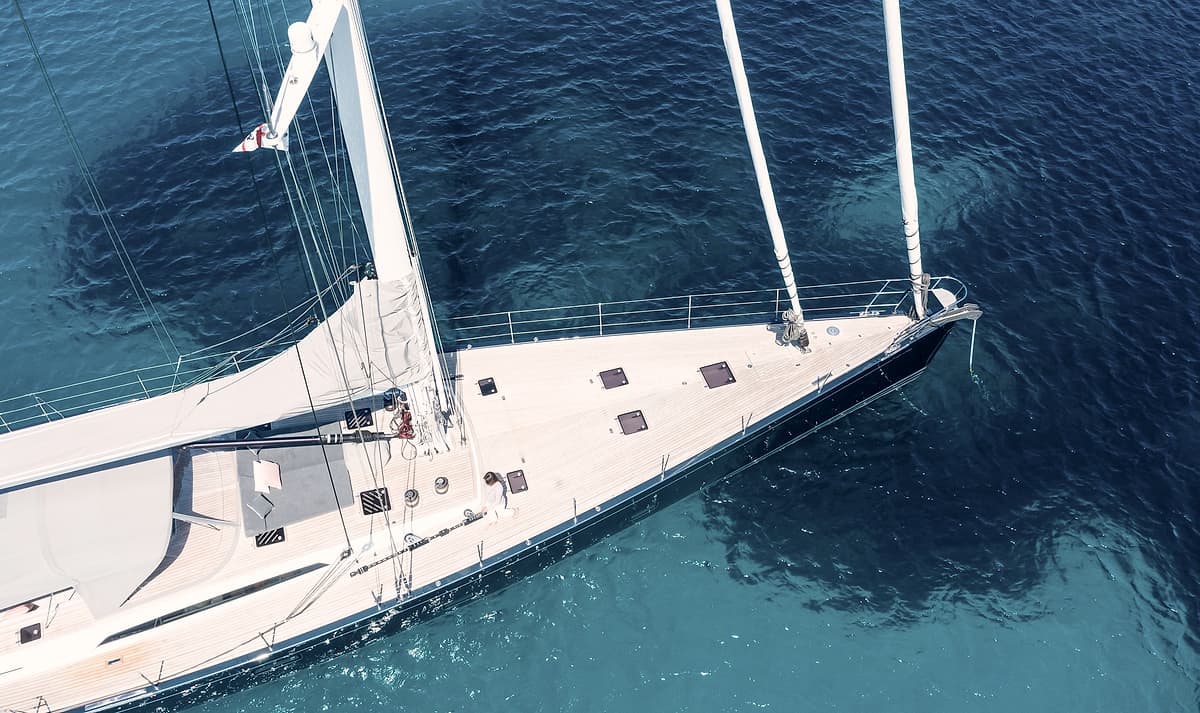 The foredeck of Sailing Yacht Freebird seen from above in clear water